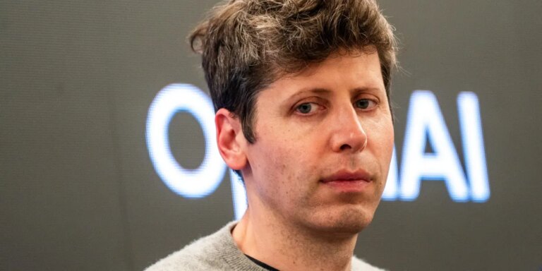 Sam Altman looks down and to the side, frowning.