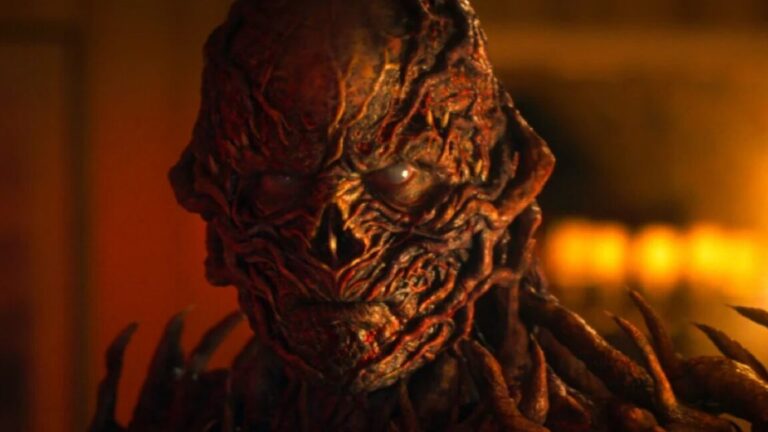 closeup of Vecna in full monster form bathed in ominous red /orange light