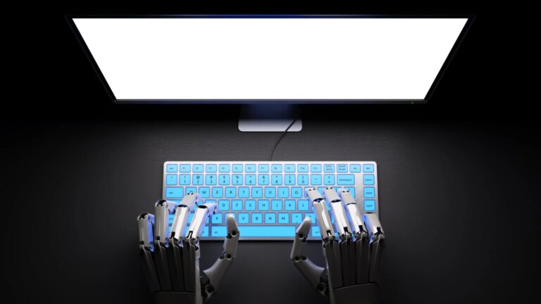 Robotic hands are seen typing on a keyboard.