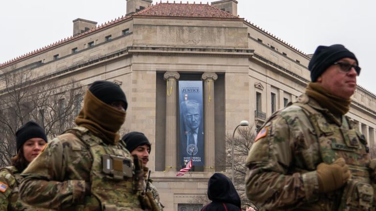 Large banner featuring Trump's face is displayed on Justice Department headquarters
