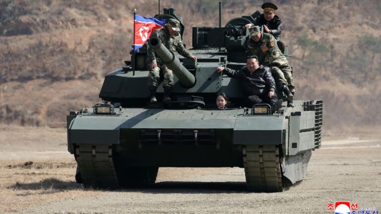 North Korean leader Kim and his daughter ride a tank together during army training